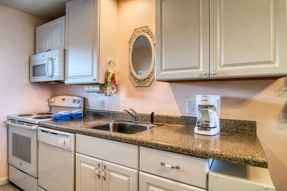 Your fully equipped kitchen awaits with granite counters, coffee maker, and all the essentials for home-cooked meals during your stay.