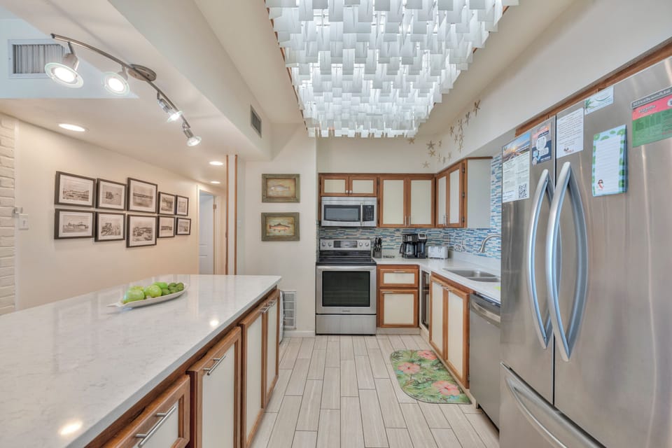 Your modern kitchen features stainless steel appliances, quartz countertops, and stylish lighting perfect for preparing memorable meals together.