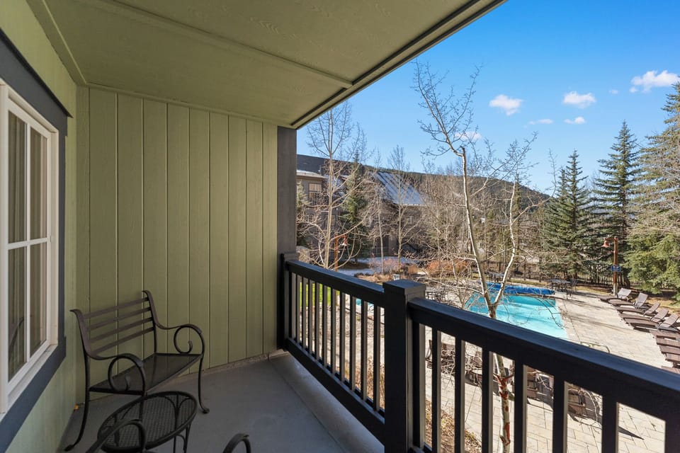 Enjoy stunning mountain vistas and pool views from your private balcony—perfect for morning coffee or evening relaxation.