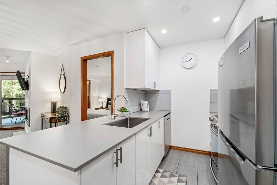 Fully equipped kitchen with stainless steel appliances—everything you need for home-cooked meals