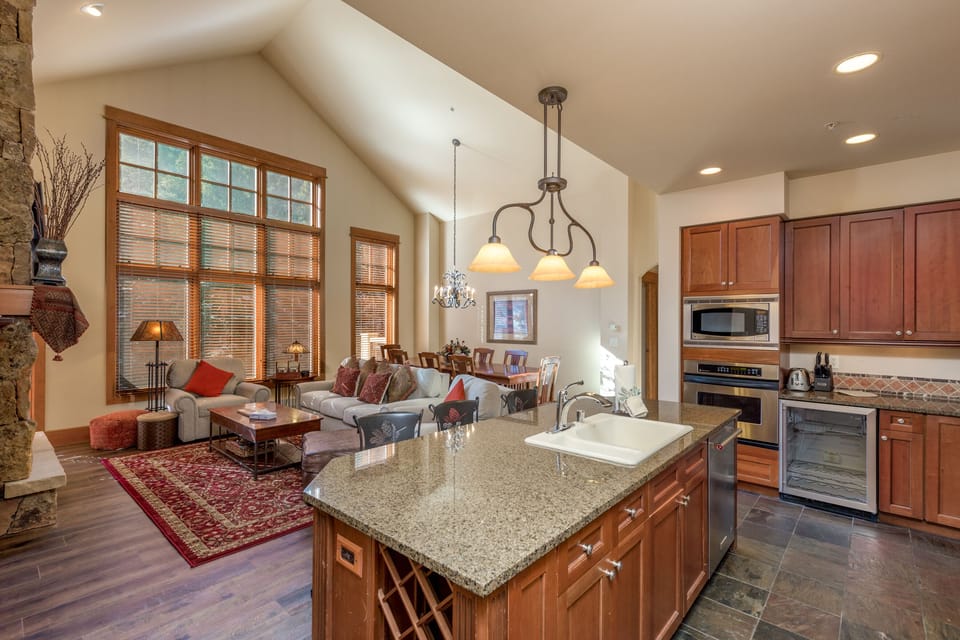 Your spacious open-plan living space flows seamlessly from kitchen to cozy seating area, perfect for gathering with loved ones.