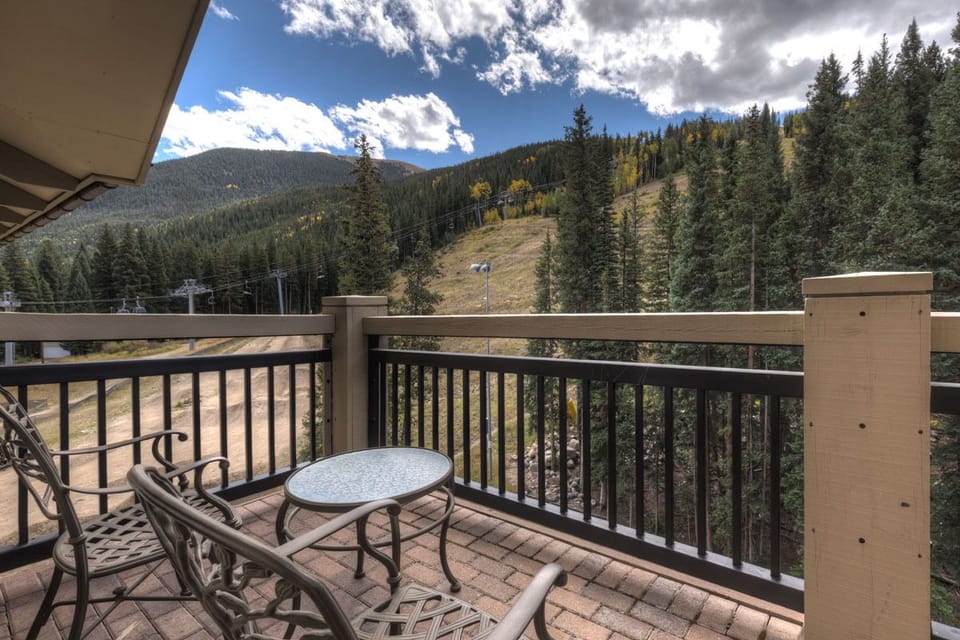 Sip your morning coffee while taking in breathtaking mountain views from your private balcony, surrounded by forest and autumn colors.