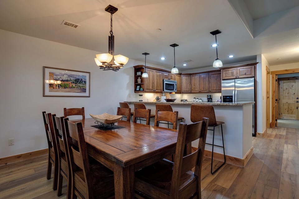 Your open-concept kitchen and dining space features rich wood finishes, granite countertops, and warm lighting for memorable meals together.