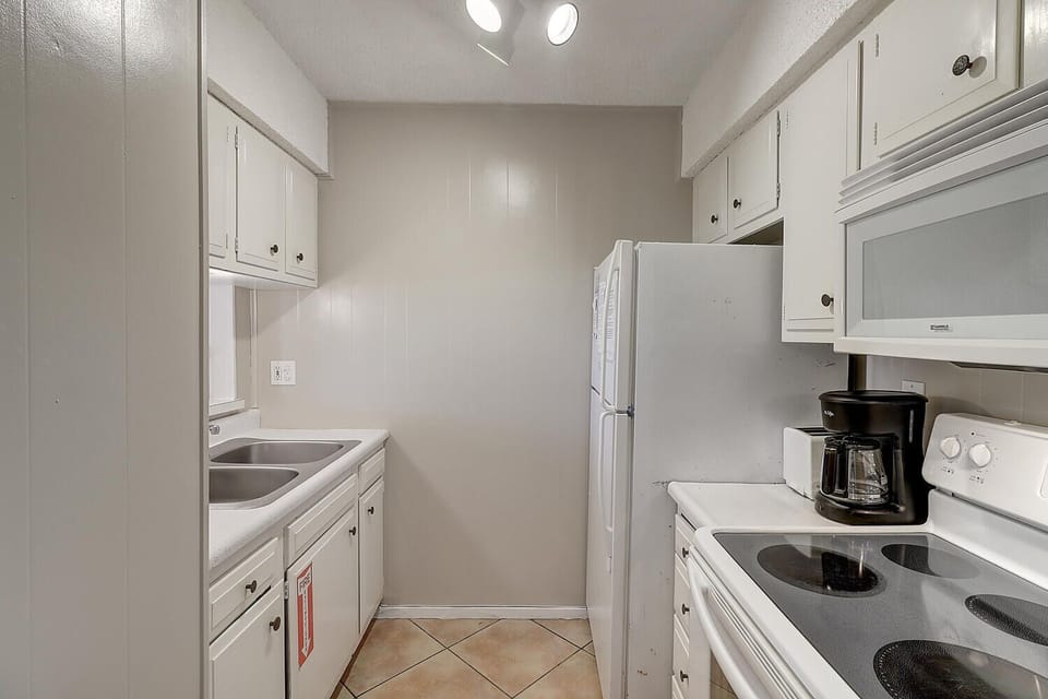 Your fully equipped galley kitchen features everything needed for home-cooked meals, from morning coffee to family dinners.
