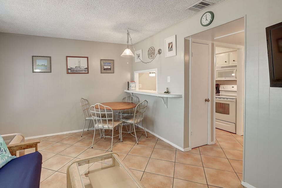 Your cozy dining area flows seamlessly into a fully-equipped kitchen, perfect for sharing meals and making memories together.