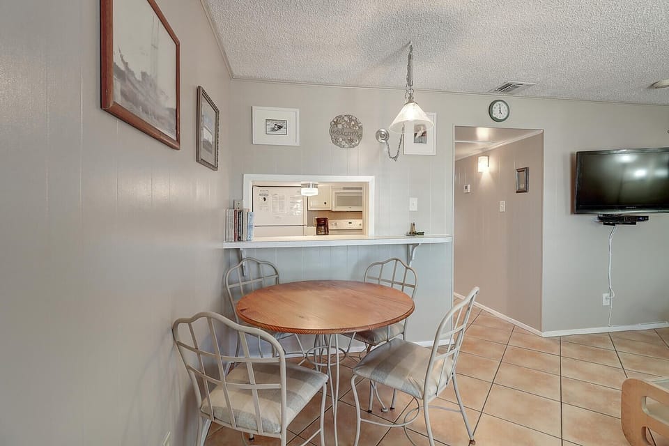 Gather around your cozy dining table for meals and memories, with the convenience of a full kitchen just steps away.