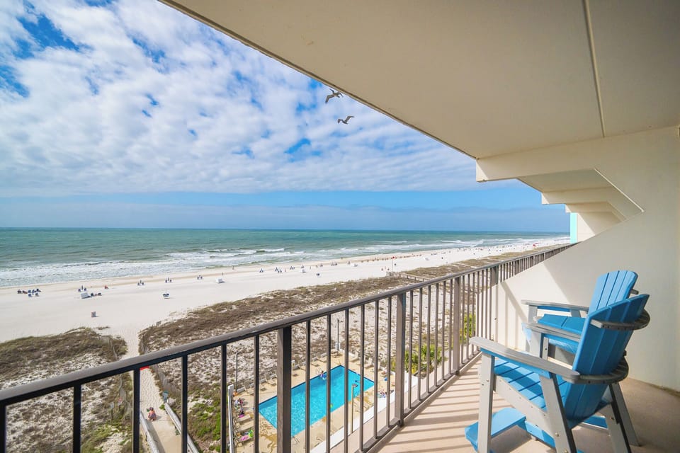 Relax on your balcony in cozy chairs, taking in the beautiful beach views and fresh coastal breezes