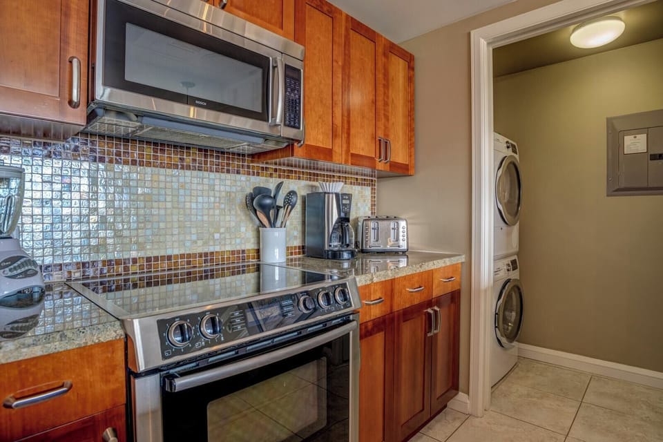 Fully equipped kitchen with modern appliances and in-unit laundry convenience.