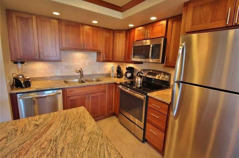 Your fully equipped kitchen features warm wood cabinetry, granite countertops, and stainless steel appliances—everything you need to whip up a delicious meal or morning coffee in style.