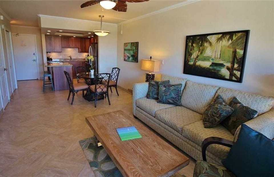 Sink into plush seating with tropical accents, unwind at your open dining area, and enjoy the ease of a fully equipped kitchen—all in your inviting, sunlit retreat.