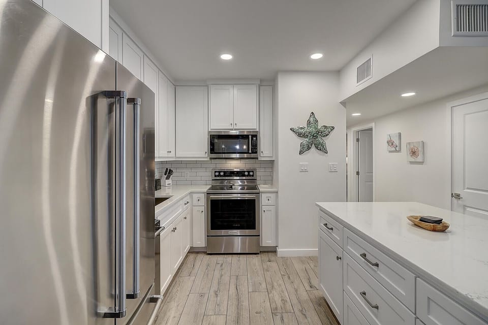 Your fully equipped kitchen features stainless steel appliances, quartz countertops, and everything you need to prepare memorable meals during your stay.