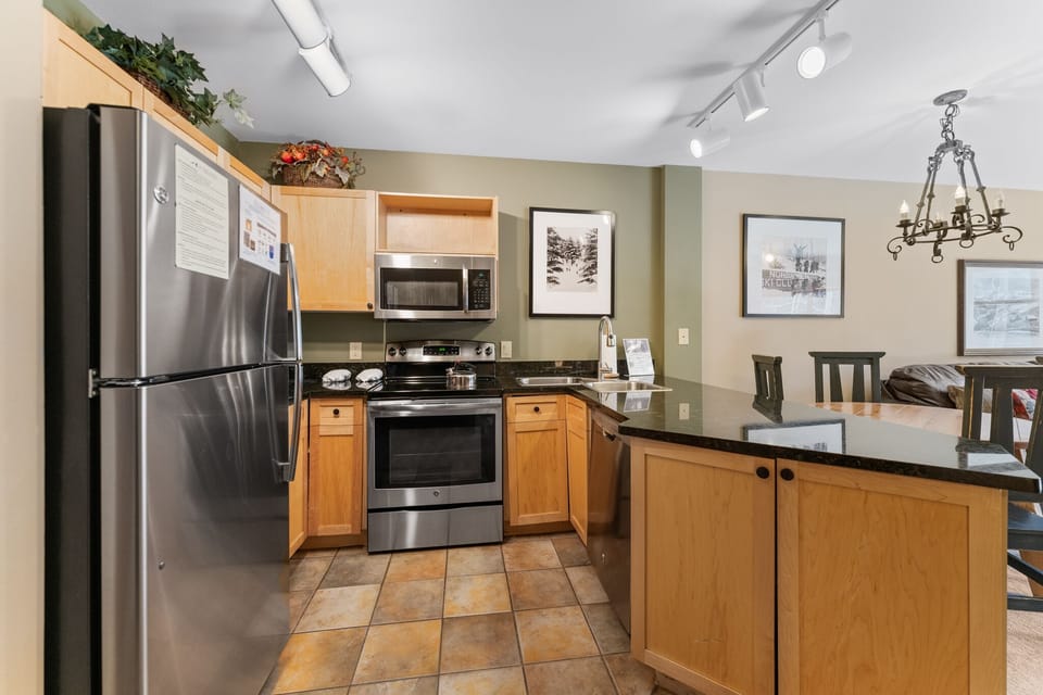 Your fully-equipped kitchen features stainless steel appliances and granite countertops, perfect for preparing meals during your mountain getaway.