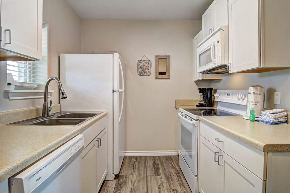 Your fully equipped galley kitchen offers everything needed for meal prep, from coffee brewing to home-cooked dinners.