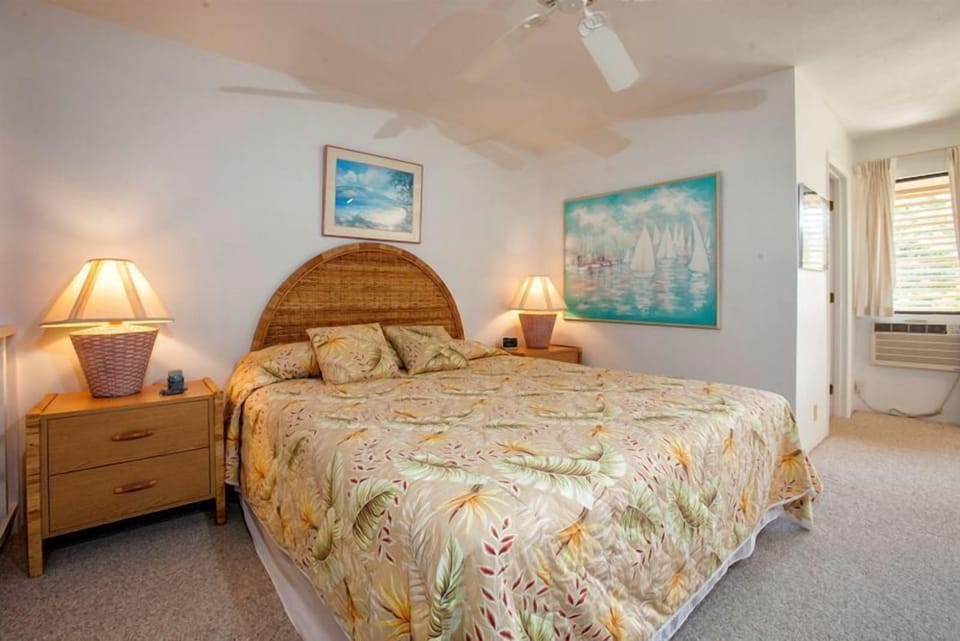 Unwind in your serene coastal retreat with soft linens, tropical prints, and gentle lighting creating a peaceful sanctuary for your island escape.