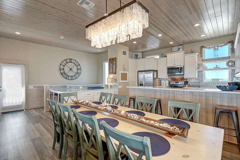 Gather your group around this stunning dining table beneath a gorgeous chandelier, with a fully equipped kitchen ready for your culinary adventures.