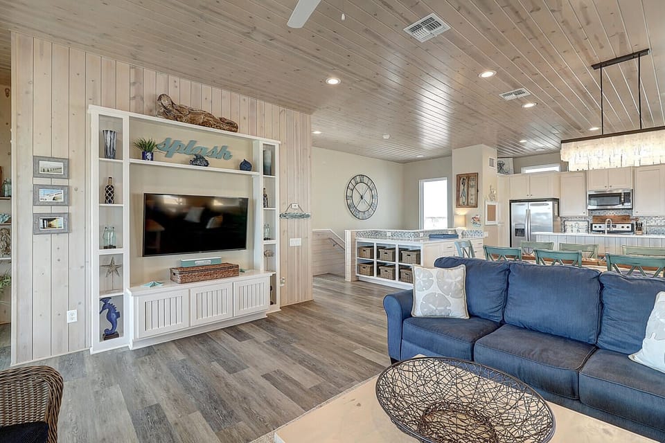 Sink into coastal comfort with your entertainment center and open kitchen just steps away for snacks.