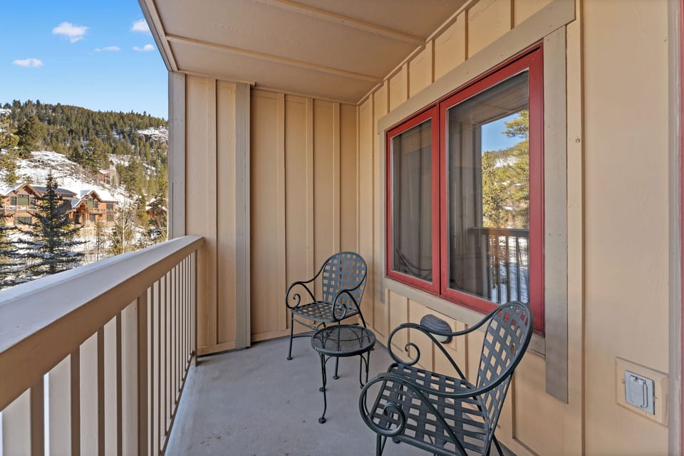 Step onto your private balcony where cozy seating awaits you to savor mountain views and fresh alpine air during peaceful moments.