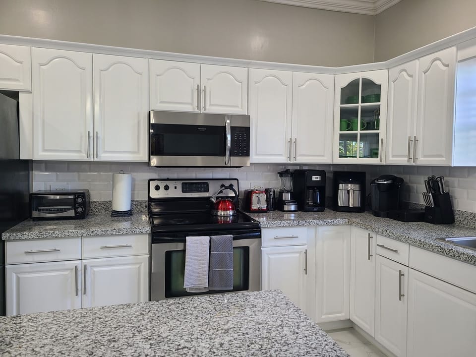 Fully equipped kitchen with all modern appliances and gadgets.