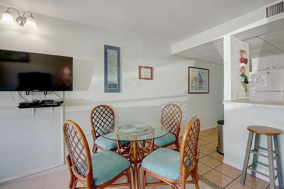 Gather around your cozy dining table for meals with coastal charm, while the open kitchen layout keeps everyone connected.