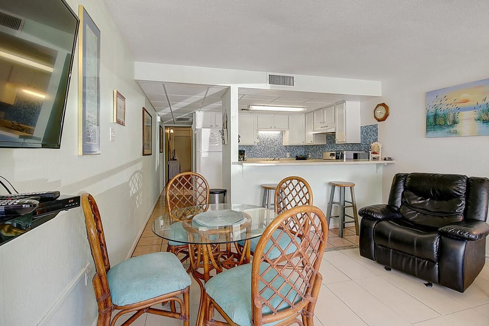 Your open-concept retreat features a full kitchen, comfortable dining space, and cozy living room perfect for relaxing after beach days.