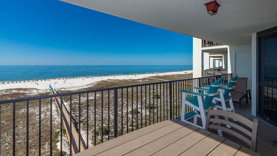 Balcony seating offers a serene view of the tranquil gulf and white sand beach, perfect for relaxation and enjoyment