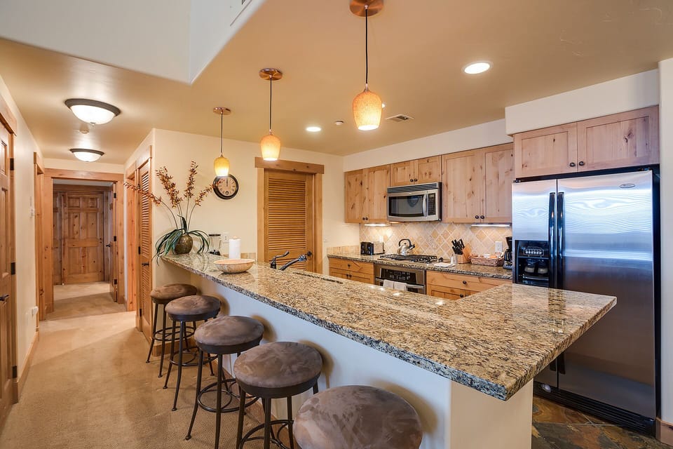 Gather around your spacious granite island with warm pendant lighting, where you'll create memories over morning coffee and evening conversations.