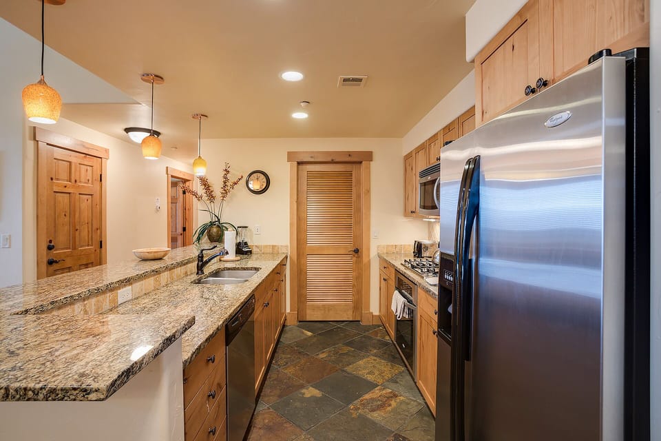 You'll love cooking in this spacious kitchen with granite counters, stainless appliances, and warm wood cabinets creating the perfect culinary retreat.