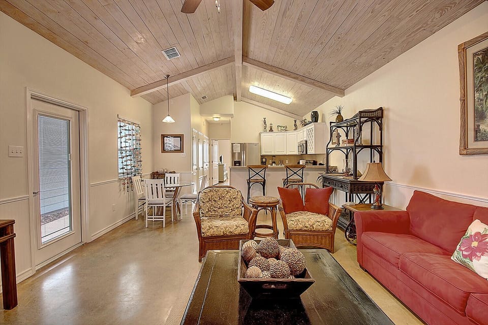 You'll love this open-concept living space where rustic wood beams meet modern comfort, creating your perfect home away from home.