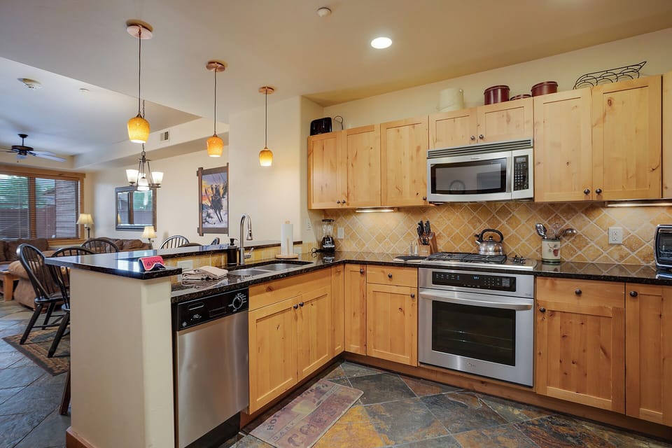 Your fully equipped kitchen features warm wood cabinetry, granite counters, and stainless appliances—perfect for preparing memorable meals together.