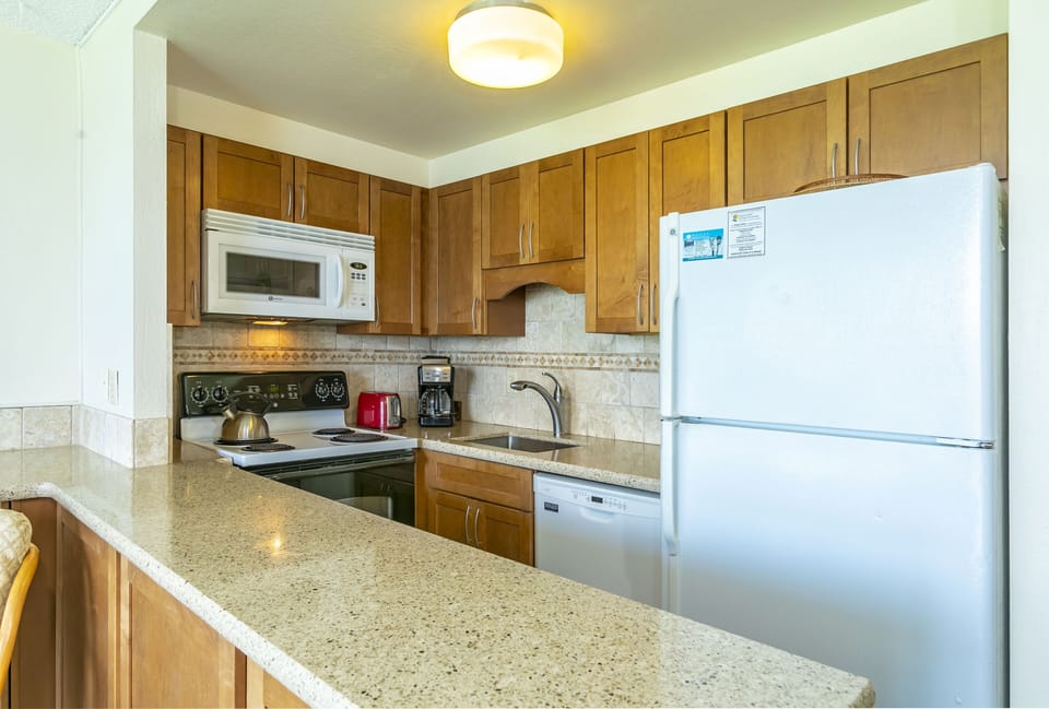 Your fully equipped kitchen awaits with granite countertops, modern appliances, and everything you need to prepare meals during your stay. Feel at home as you whip up snacks or full dinners.
