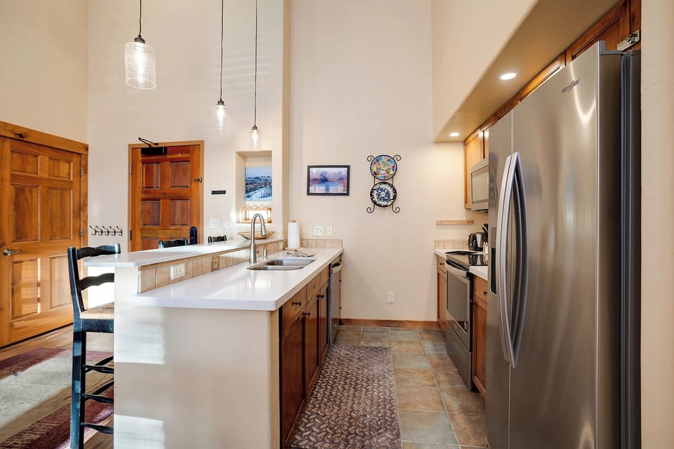 Your gourmet kitchen awaits with sleek stainless appliances, spacious island, and warm wood cabinetry for memorable meal prep.
