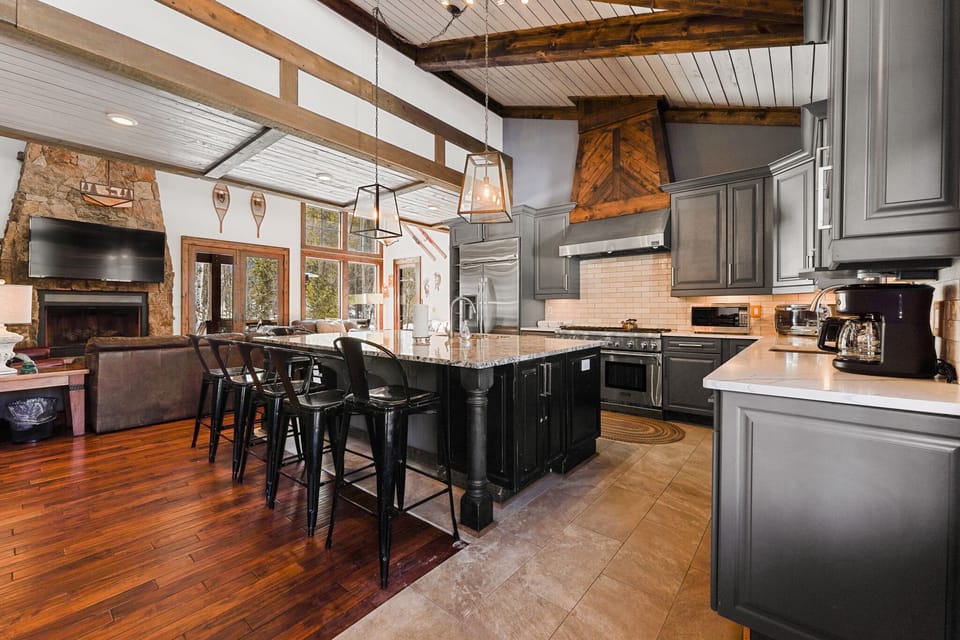 Cook memorable meals in this stunning kitchen with rustic beams, granite island, and professional appliances that make vacation dining effortless.