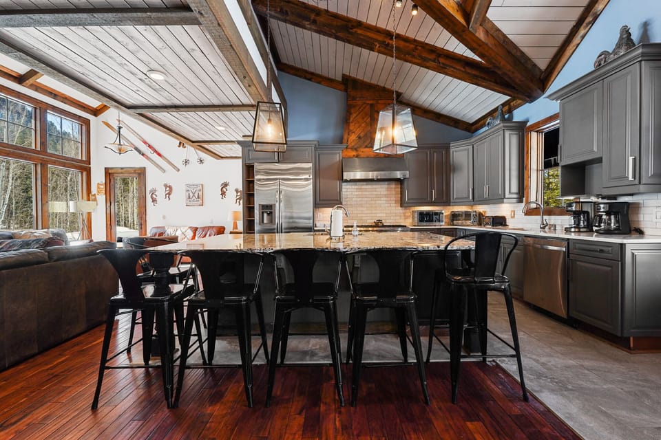 Your gourmet kitchen welcomes you with vaulted ceilings, exposed beams, and a spacious island perfect for gathering with loved ones.