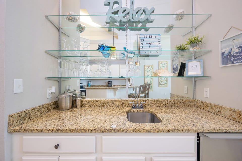 Mix refreshing drinks at your wet bar, enjoying the inviting vibe as you prepare for beachside adventures ahead