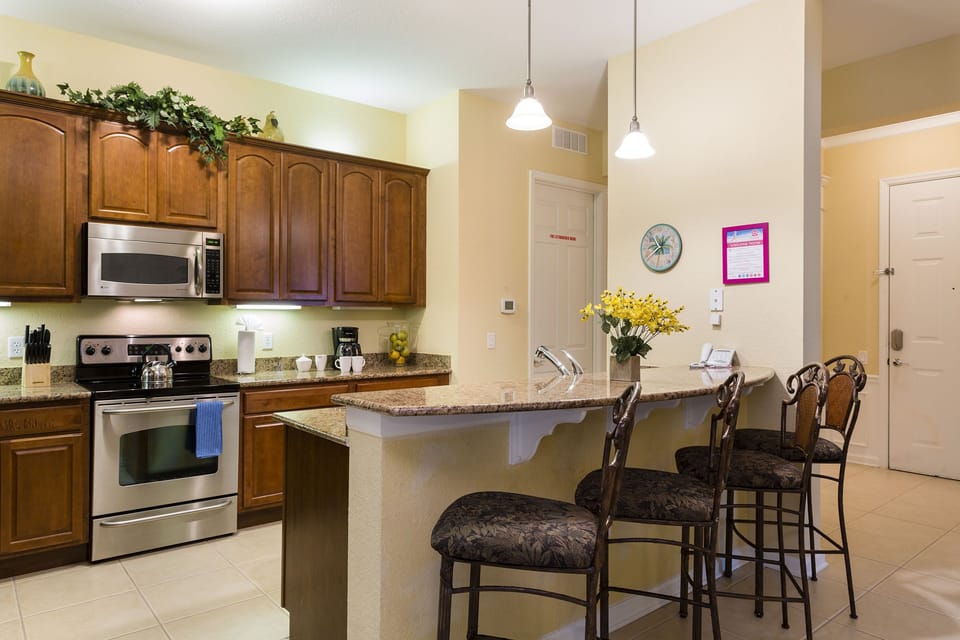 Step into a world of culinary luxury in our open-concept kitchen of the condo in Orlando - Fully furnished with stylish details and equipped with all kitchen accessories that makes cooking a delight - Availability of high chairs at breakfast bar