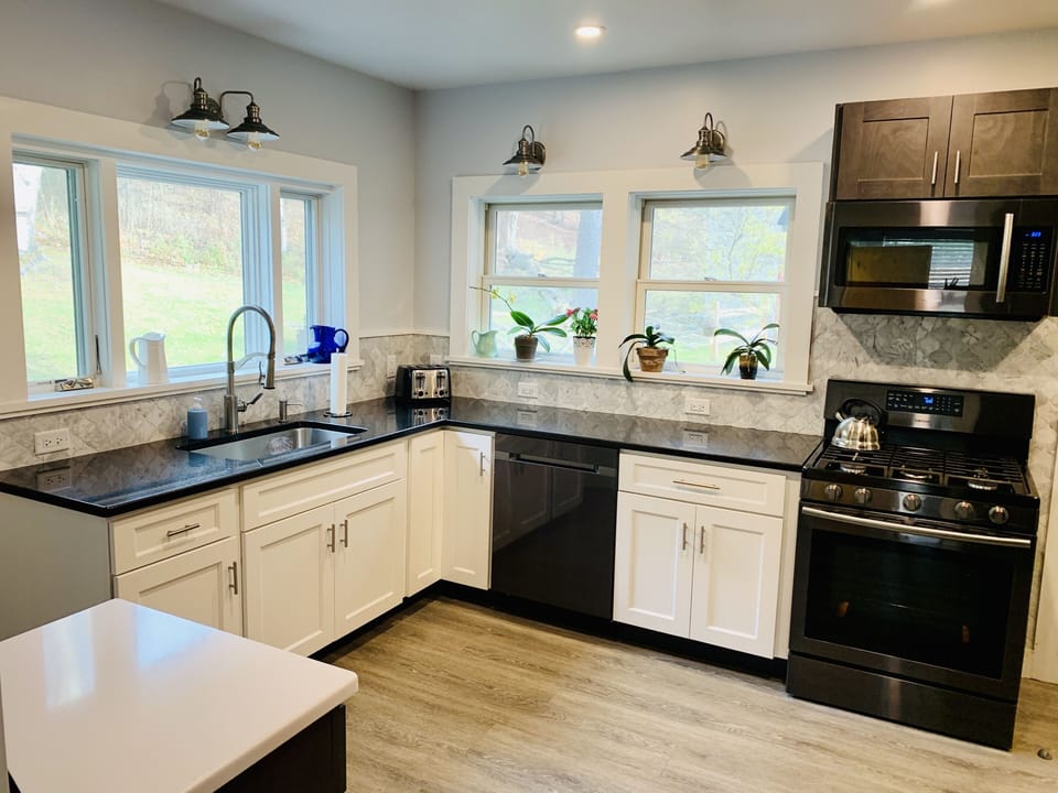 Kitchen with Granite Countertops and Black Stainless Steal Appliances