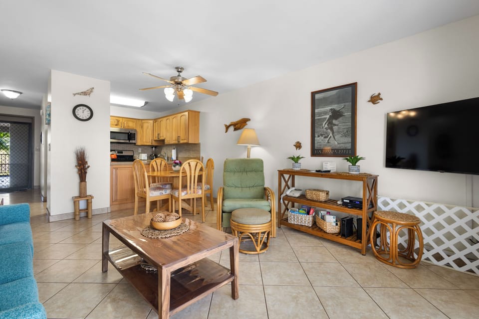 Relax in your bright, open living space with comfy seating, a full kitchen, and coastal charm—complete with ceiling fan and entertainment center for easy unwinding.