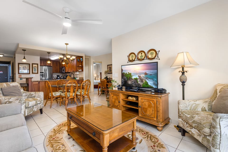 Unwind in your spacious living area, where warm wood tones meet coastal comfort. Relax on plush seating, enjoy your favorite shows, and savor meals together in this inviting open-plan retreat.