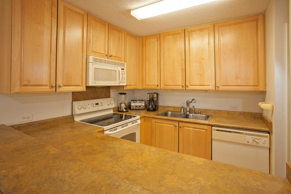 Cook your favorite meals in this fully equipped kitchen, featuring ample counter space, modern appliances, and plenty of storage for all your culinary needs.