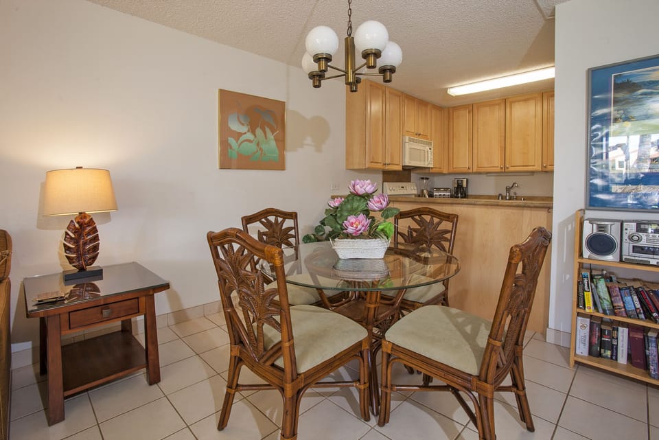 Step into this inviting dining and kitchen space, where tropical-inspired décor meets home comfort. Gather around the elegant glass-top table, prepare meals in your fully equipped kitchen, and enjoy a relaxing retreat.