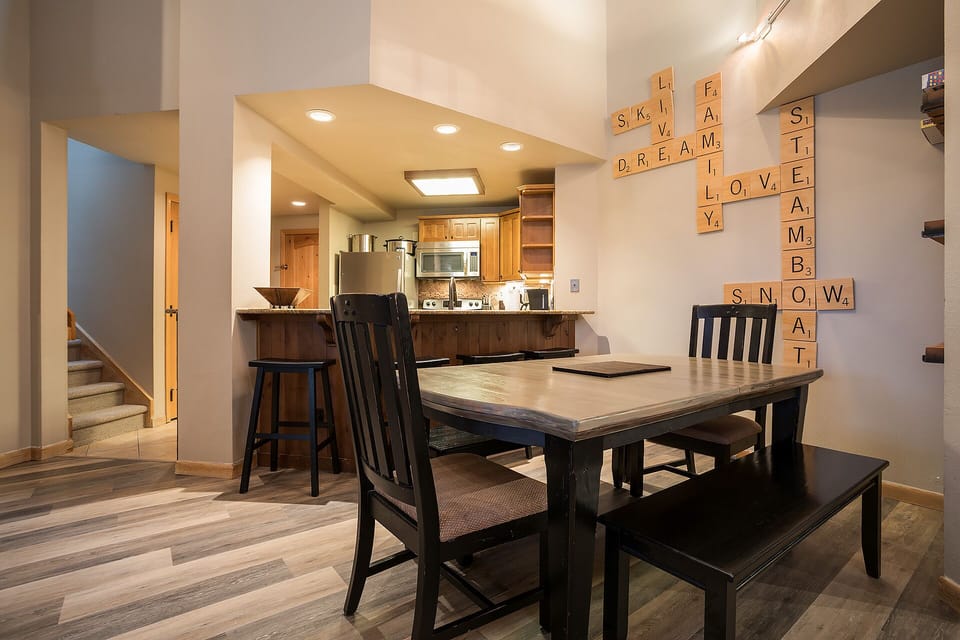 Gather around your spacious dining table for meals and game nights, with a fully equipped kitchen just steps away for easy entertaining.