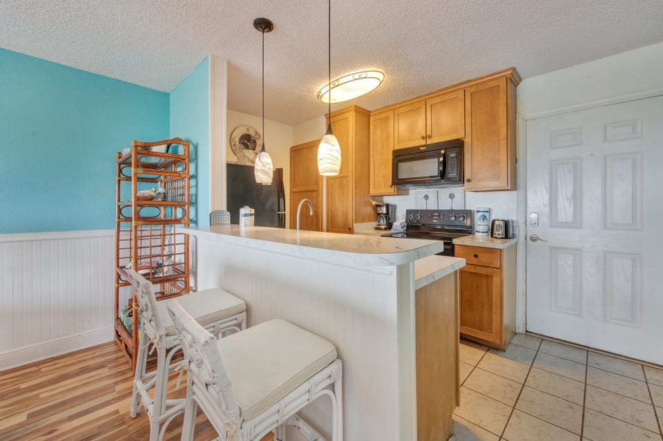 Your bright kitchen welcomes you with warm wood cabinets, modern appliances, and a breakfast bar perfect for morning coffee or casual meals.
