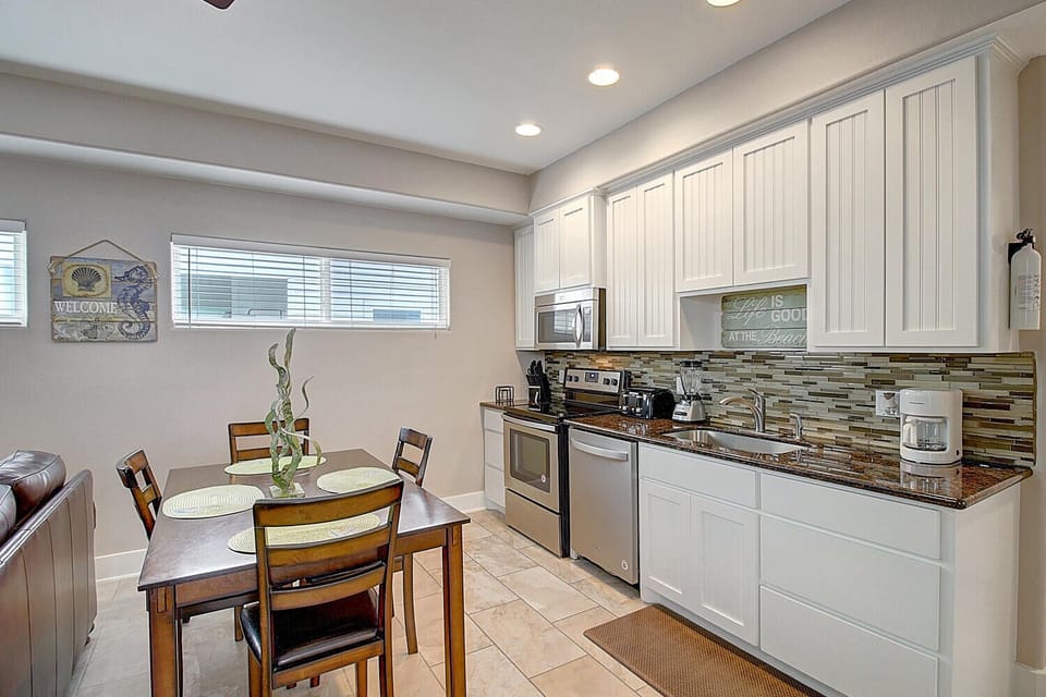 Your bright, fully-equipped kitchen invites you to prepare meals with granite counters, modern appliances, and a cozy dining space.