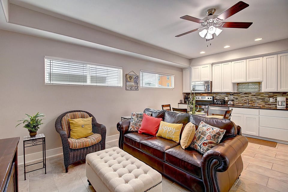 Sink into the plush leather sofa and colorful pillows while your kitchen awaits nearby—perfect for relaxing after cooking your favorite meal.