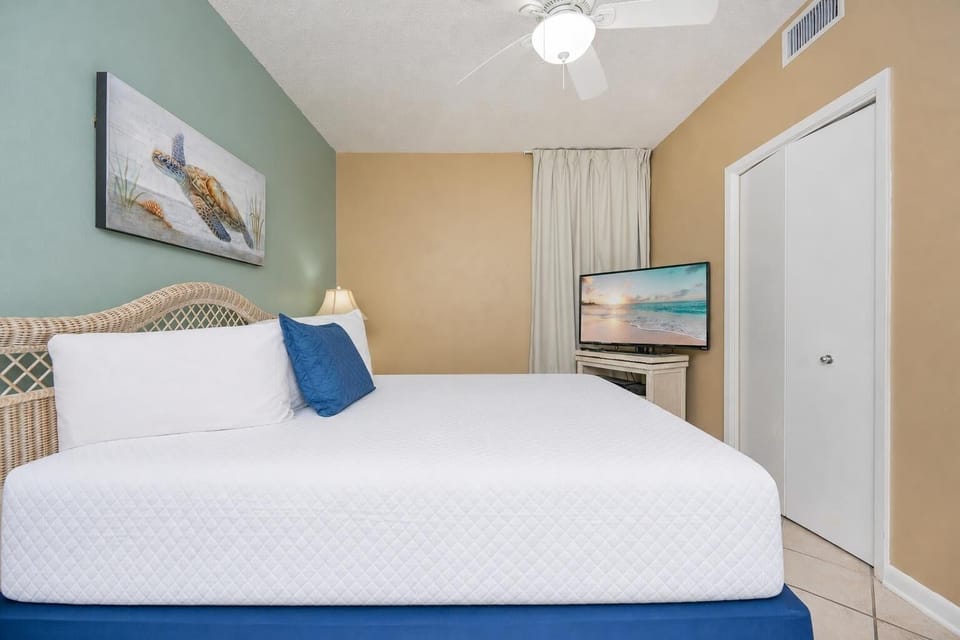 Drift into restful slumber on a plush king bed, surrounded by calming beach decor and inviting lighting