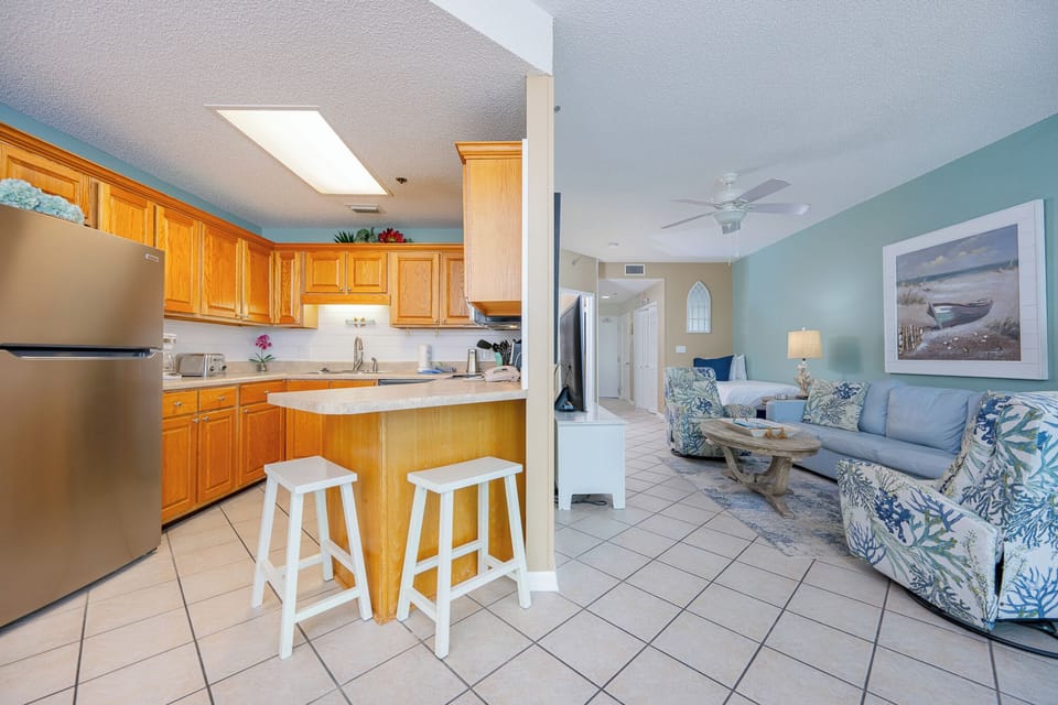Savor your morning coffee at the kitchen counter while soaking in the inviting beach vibe around you