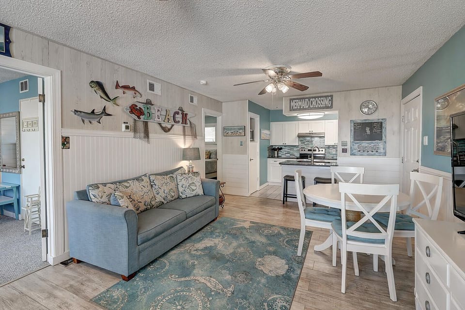 Relax in your coastal-themed living space where sea-inspired decor and ocean blues create the perfect beach getaway atmosphere.