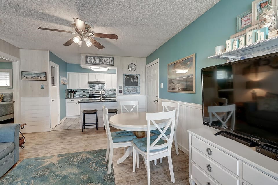 Relax in your coastal-inspired living space where turquoise walls and nautical touches create perfect beach vibes for your getaway.