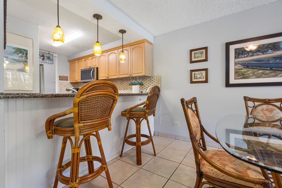 Gather around the breakfast bar for coffee and conversation, or settle into the dining nook for meals together—coastal charm meets everyday comfort in your vacation kitchen.