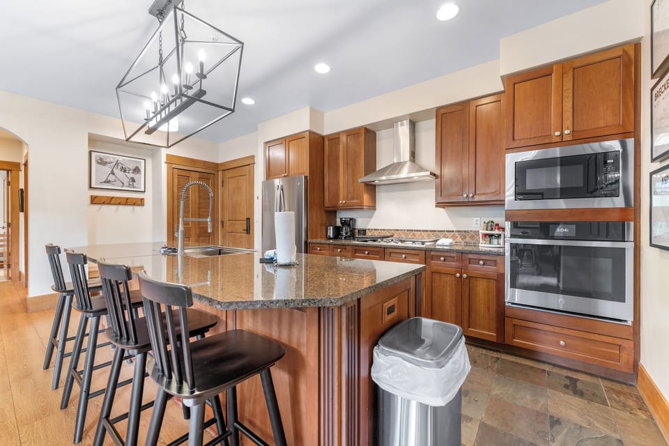 Your gourmet kitchen awaits with granite counters, premium appliances, and spacious island seating for memorable meal preparations.